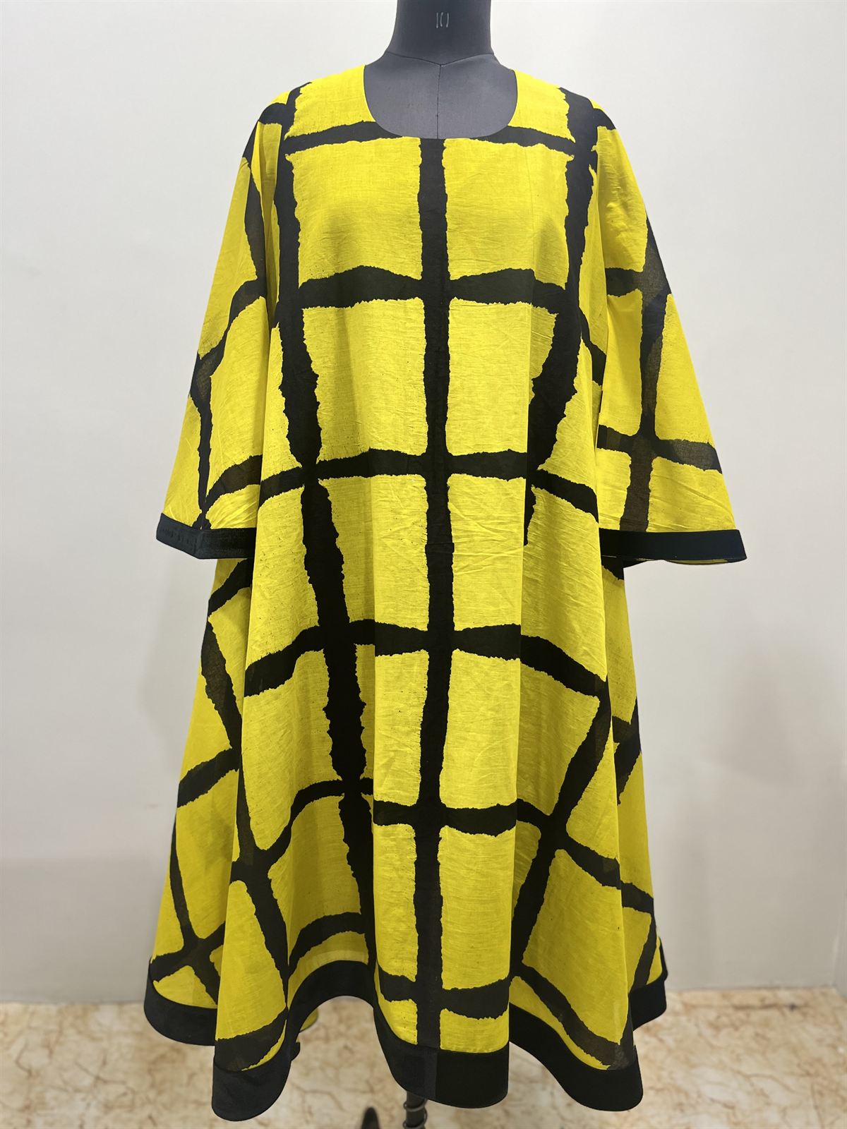 Yellow flared dress with a bold black grid print